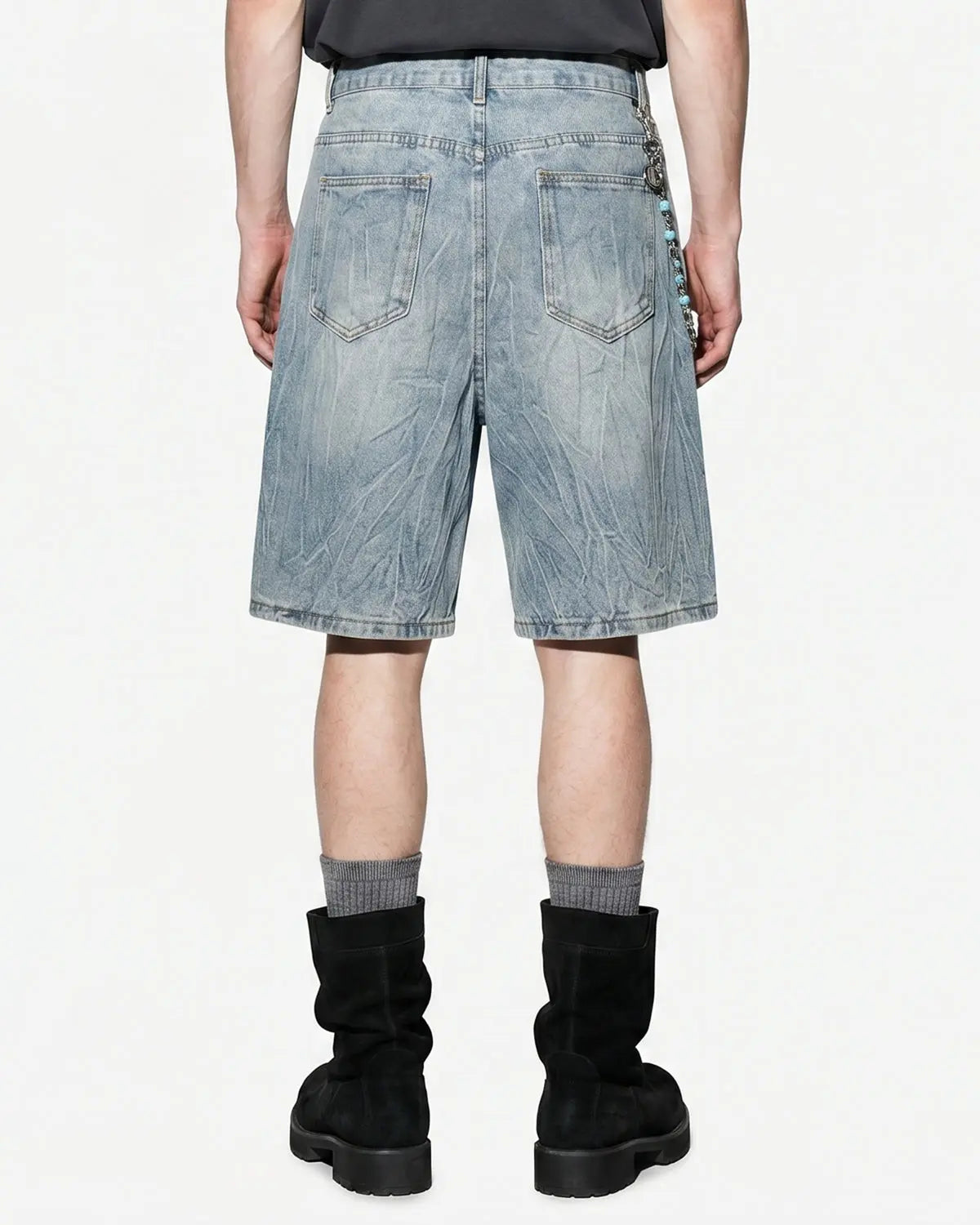 Textured washed longline jorts from INFLATION Streetwear, showing distressed denim fabric and relaxed fit pants style.