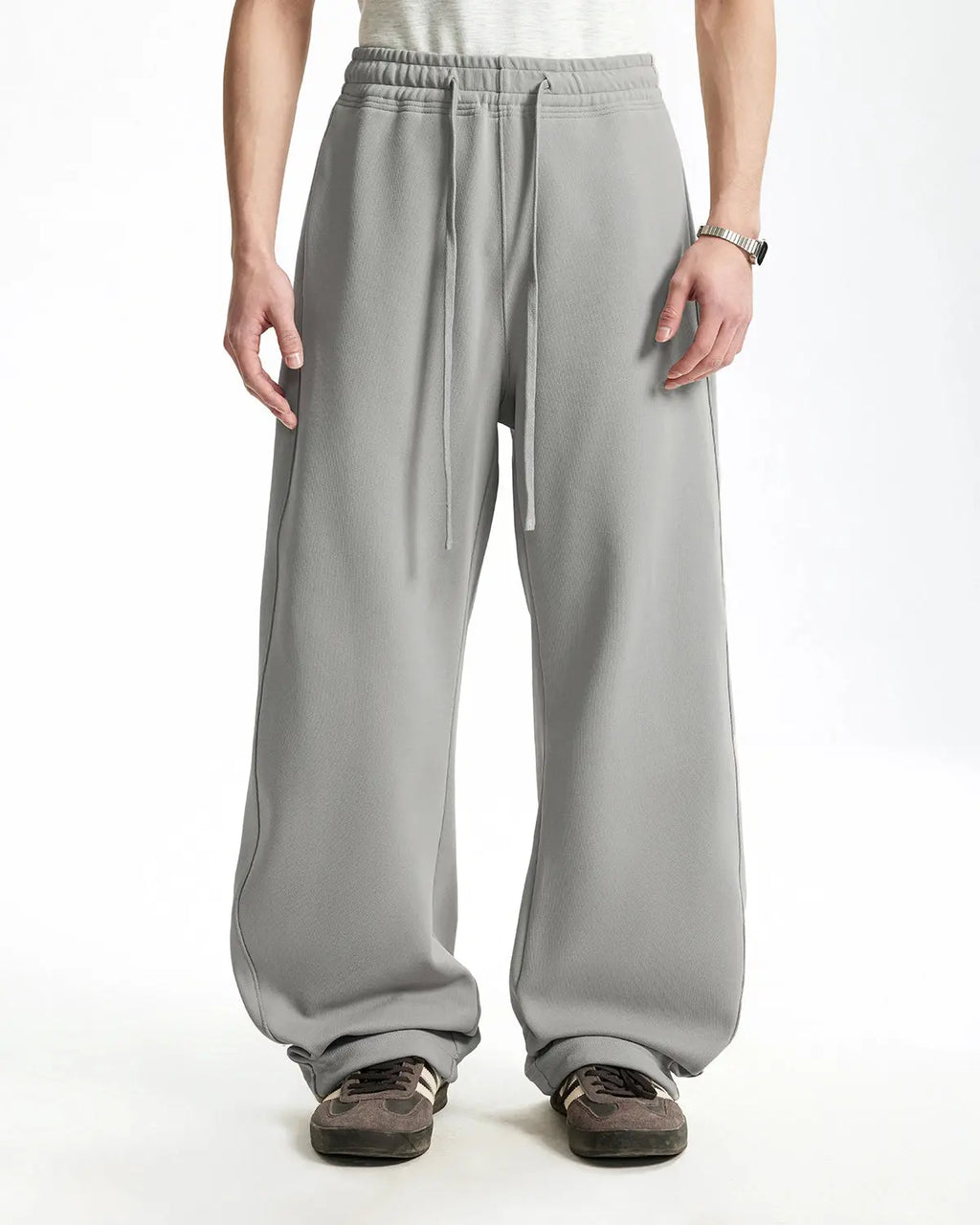 Grey baggy sweatpants by INFLATION with relaxed fit and drawstring waist, casual style, shown on a model.