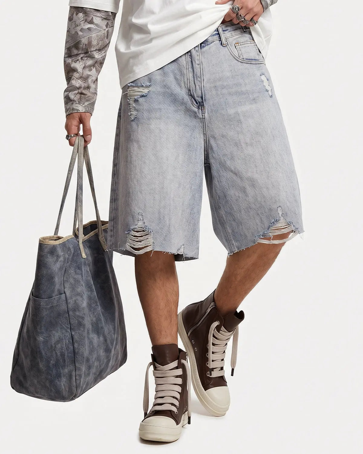 Inflation brand adjustable waist baggy jorts, casual denim pants with a relaxed fit and distressed details.