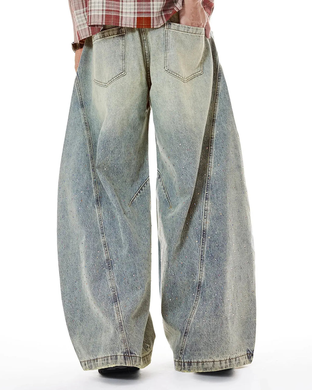 Colorful rhinestones on ripped baggy jeans by INFLATION, streetwear pants with bold, vibrant embellishments and distressed style.