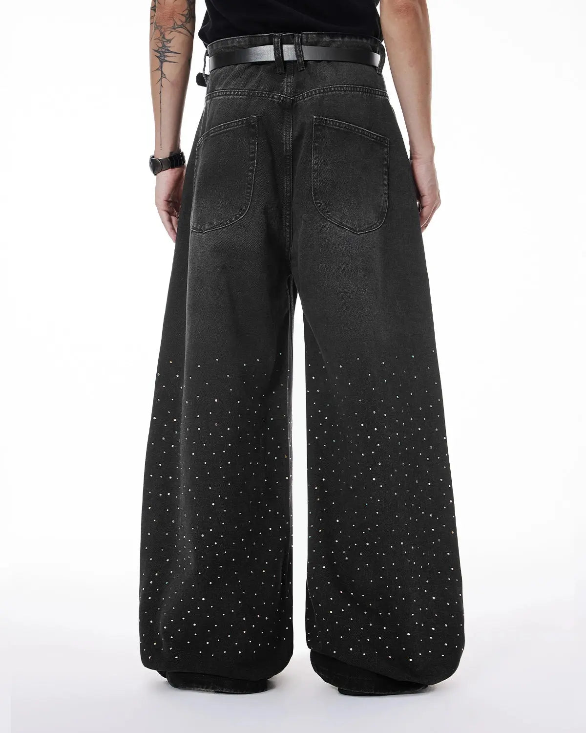 Acid washed rhinestone baggy jeans by INFLATION, featuring a relaxed fit with rhinestone embellishments and distressing.