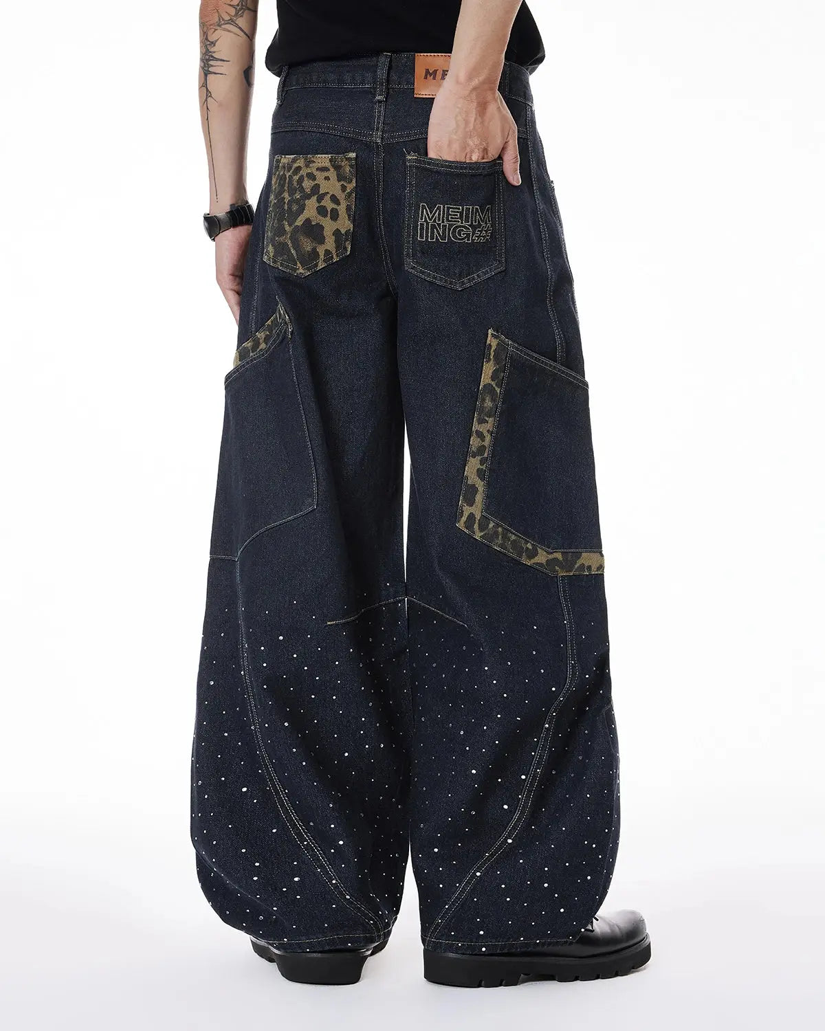 Leopard patch rhinestone barrel jeans by INFLATION featuring distressed details and bold streetwear style.