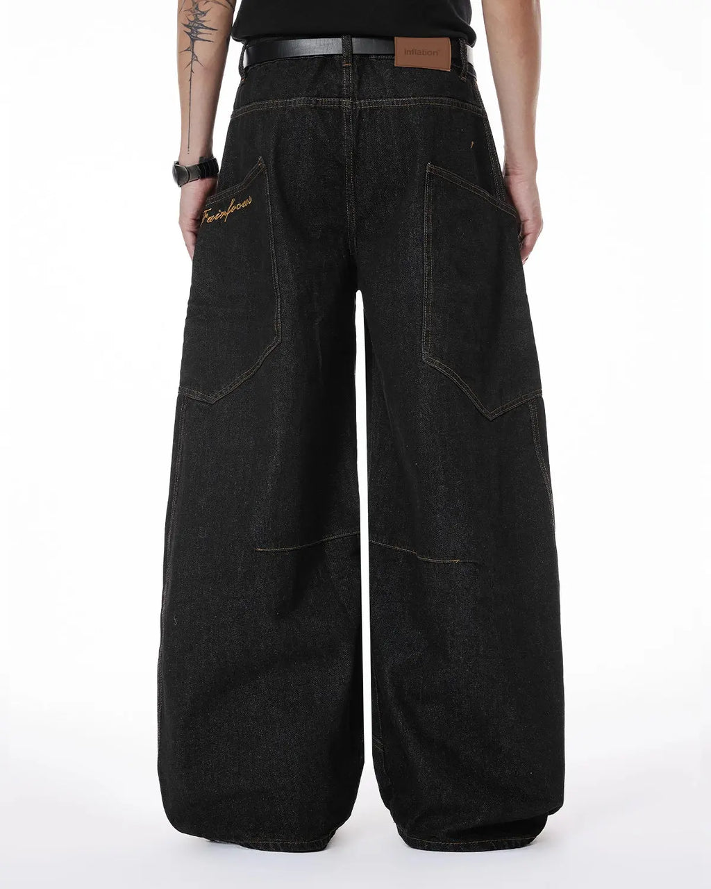 Colorful rhinestone raw barrel jeans by INFLATION featuring vibrant embellishments and a distressed streetwear style.