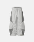 Inflation Contrast Panel Baggy Track Pants featuring color block panels and relaxed fit for streetwear style.