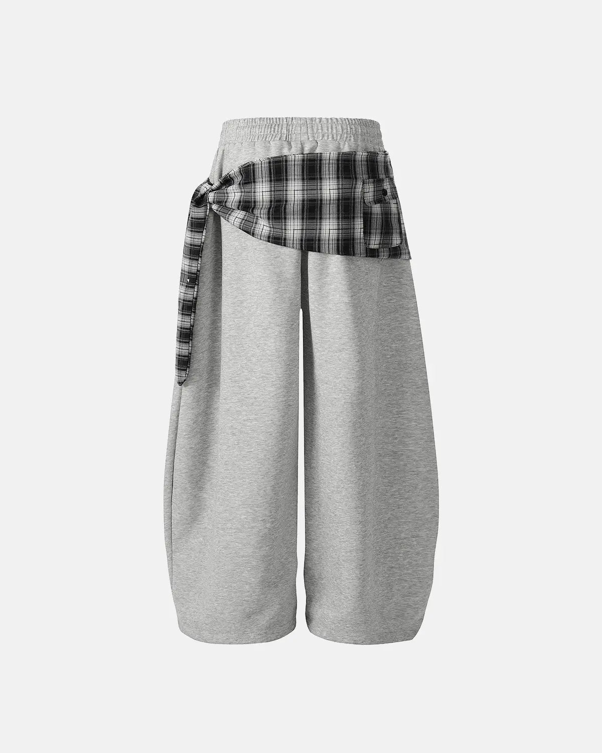 Inflation Streetwear plaid layered baggy sweatpants with a relaxed fit and layered design, shown in a casual outdoor setting.