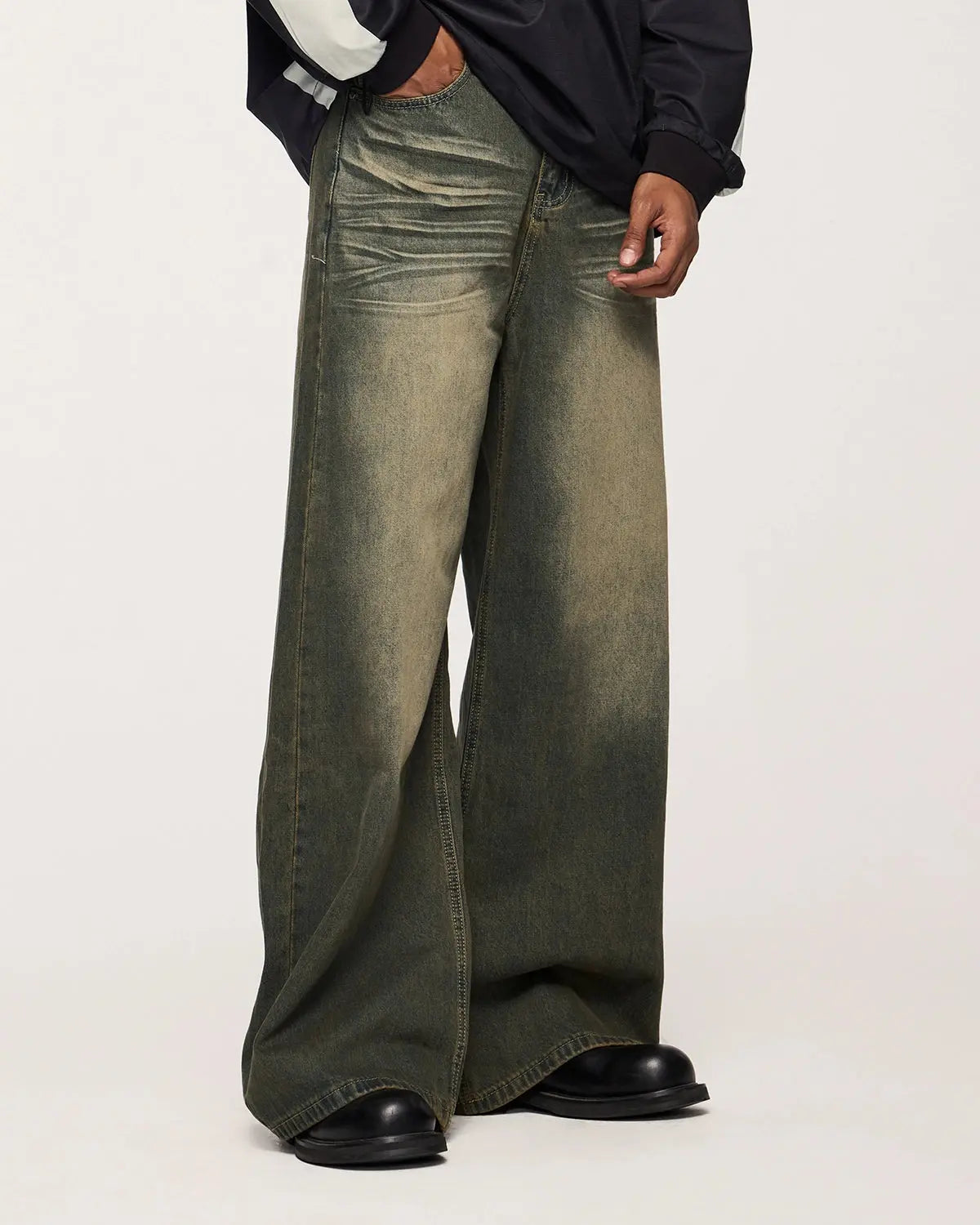 Inflation streetwear washed loose-fit denim pants with distressed details, casual urban style, shown on a model.