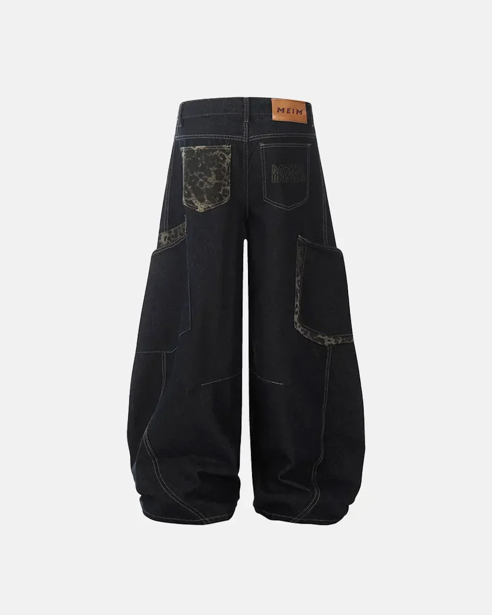 Leopard patchwork barrel jeans by INFLATION featuring bold animal print, relaxed fit, and stylish streetwear design.
