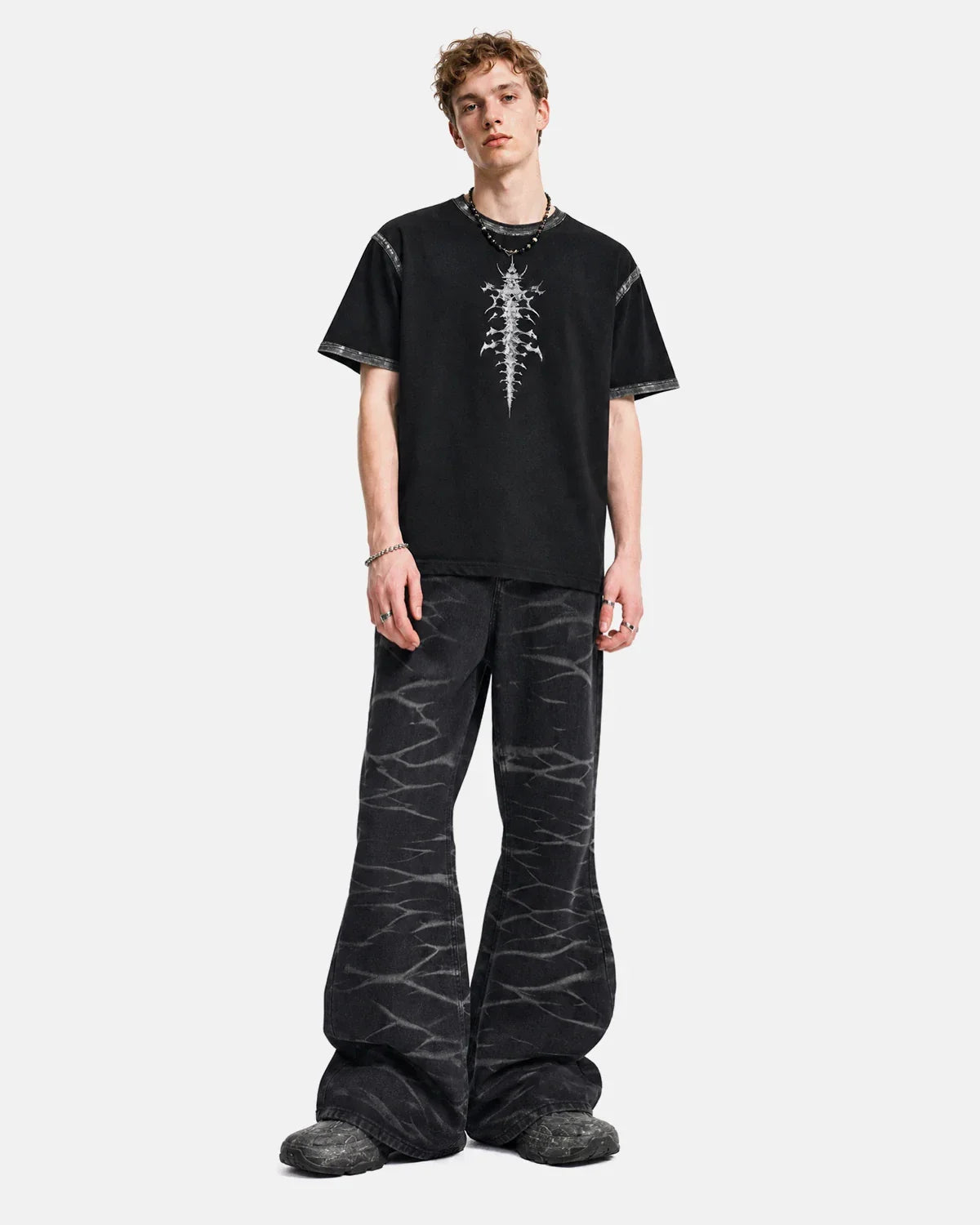 Black Whisker Wash Bootcut Jeans from INFLATION Streetwear, showing the fitted waist and flared leg design with whisker fade details.