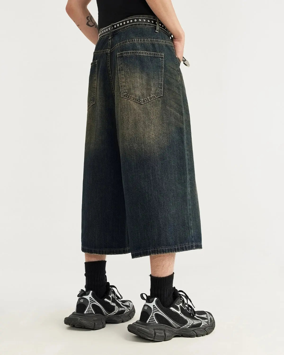 Acid washed longline baggy denim jorts by INFLATION, casual streetwear pants with distressed, oversized fit and frayed hems.