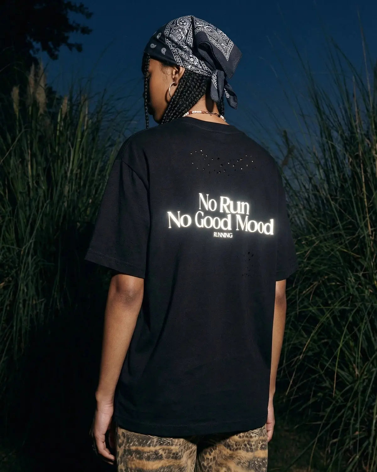 Distressed reflective washed T-shirt by INFLATION, featuring a streetwear style with faded and worn design details.