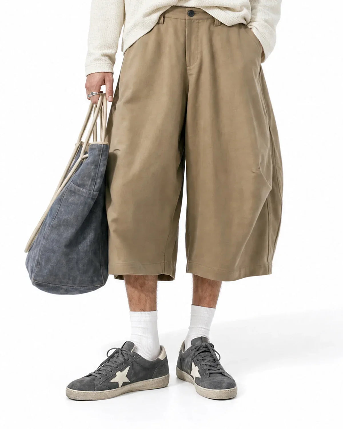 Inflation Streetwear pleated barrel-tailored Bermuda shorts in neutral fabric, displayed flat with a focus on the waistband and pleats.