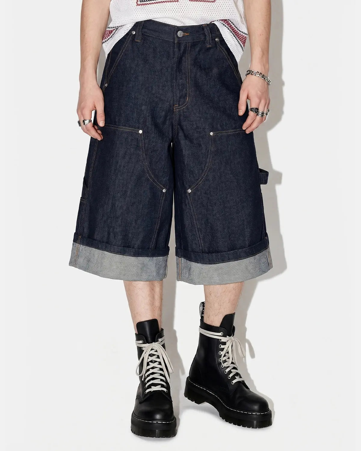 Raw denim carpenter long jorts by INFLATION, casual pants with rugged style and functional pockets, shown on a model.