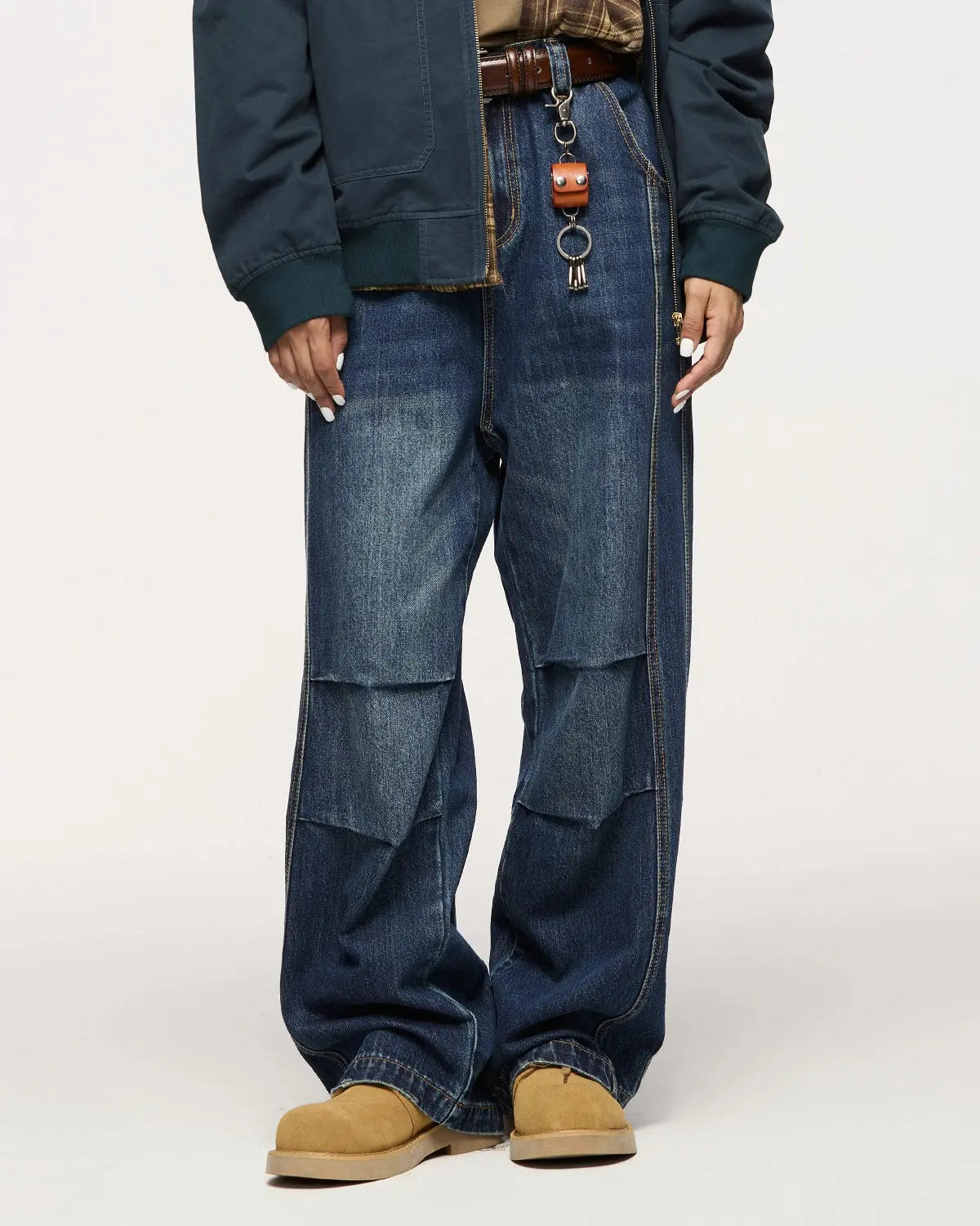 INFLATION faded dirty baggy cargo jeans with distressed details, relaxed fit, and multiple pockets, displayed on a hanger.
