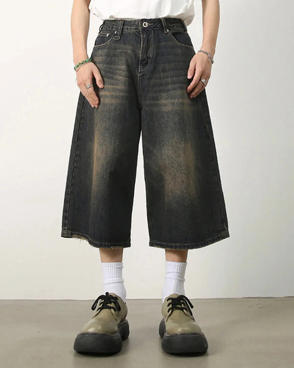 Baggy jumbo jorts by INFLATION featuring oversized denim shorts with a relaxed fit and distressed details.