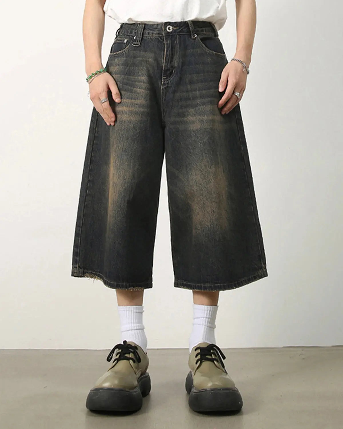 Baggy jumbo jorts by INFLATION featuring oversized denim shorts with a relaxed fit and distressed details.