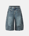 Inflation brand studded washed long baggy jorts, denim pants with distressed details and metal studs, casual streetwear style.