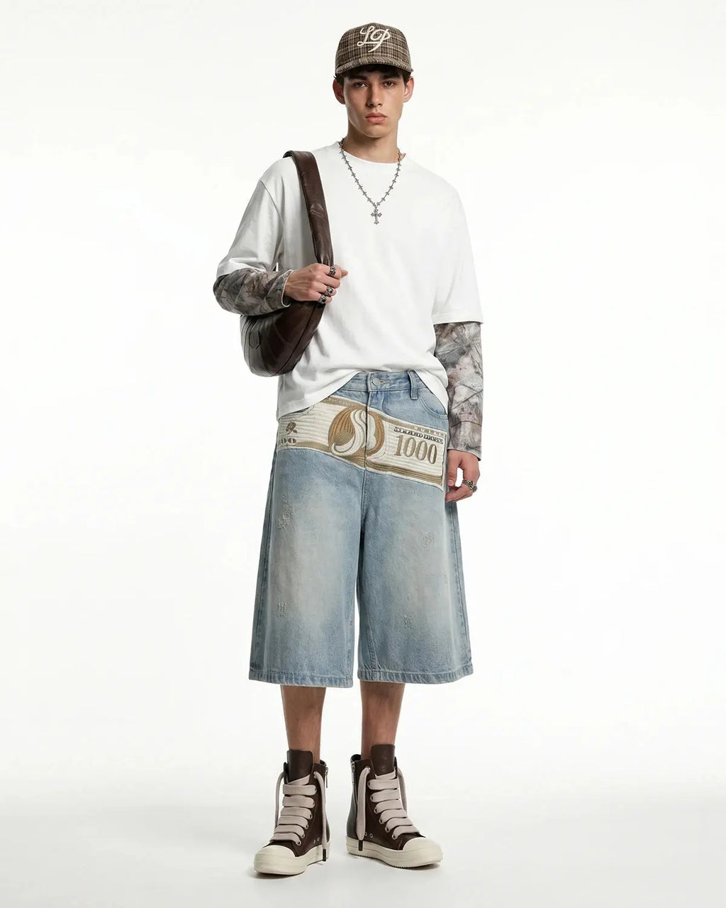 Inflation Dollar Patch Embroidery denim jorts featuring distressed denim and embroidered dollar patch details.