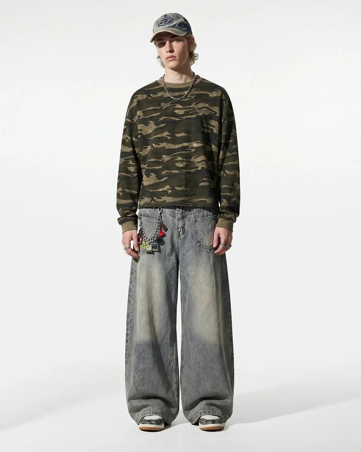 Distressed eyelet barrel jeans by INFLATION featuring a relaxed fit, ripped details, and eyelet accents on denim.