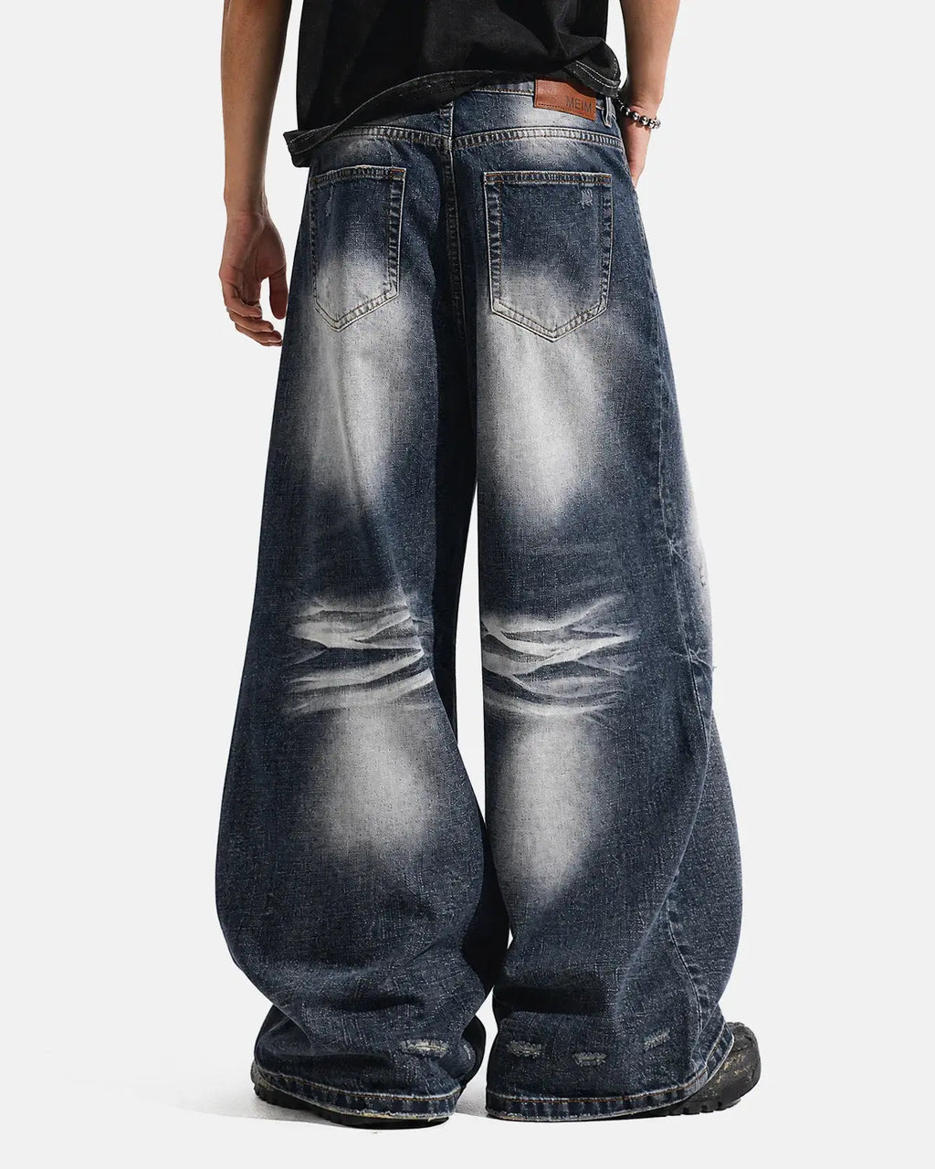 Faded Whisker Baggy Jeans by INFLATION, relaxed-fit streetwear denim with distressed details and faded wash appearance.