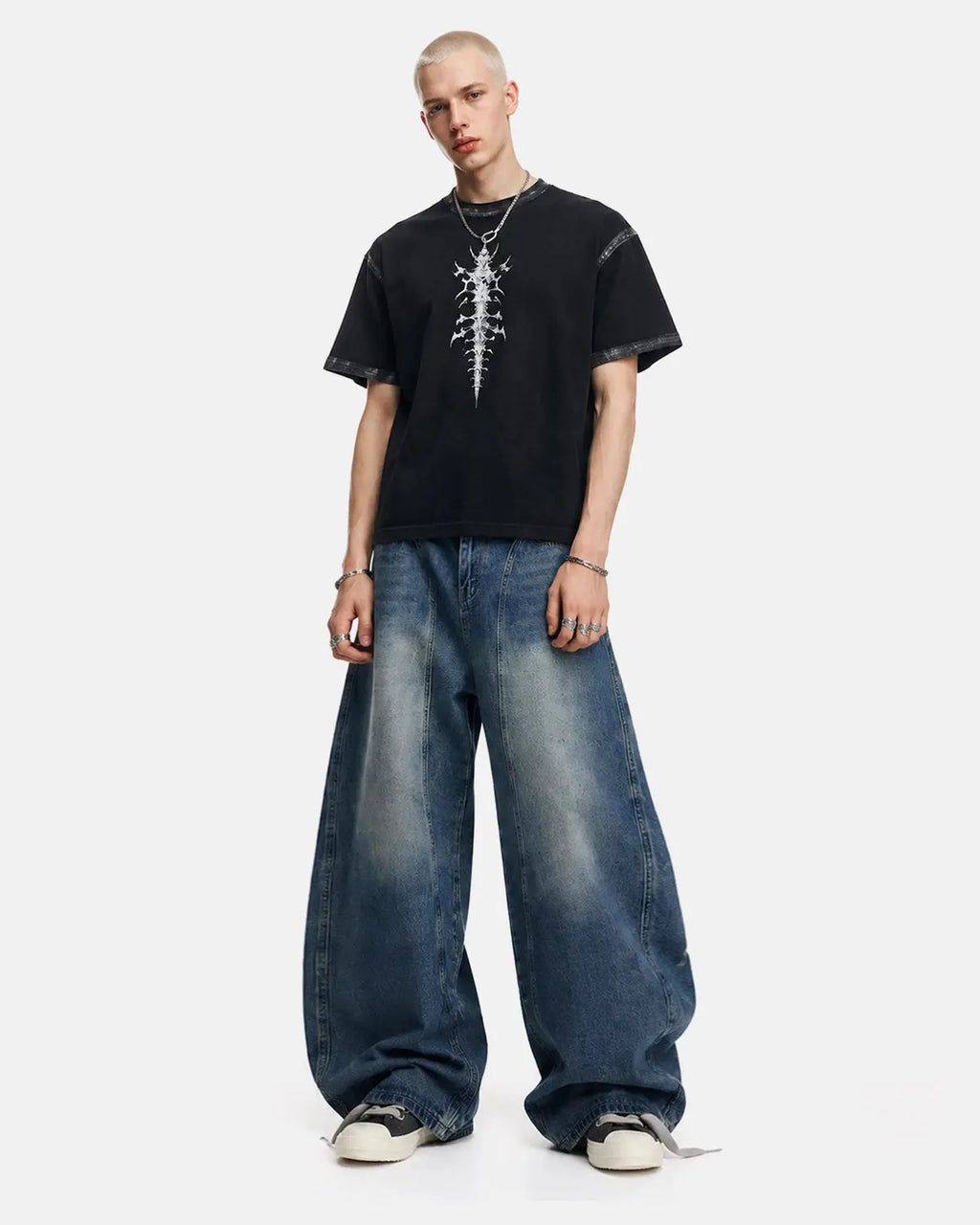 Deconstructed barrel jeans by INFLATION, stylish streetwear pants with unique distressed and layered design details.