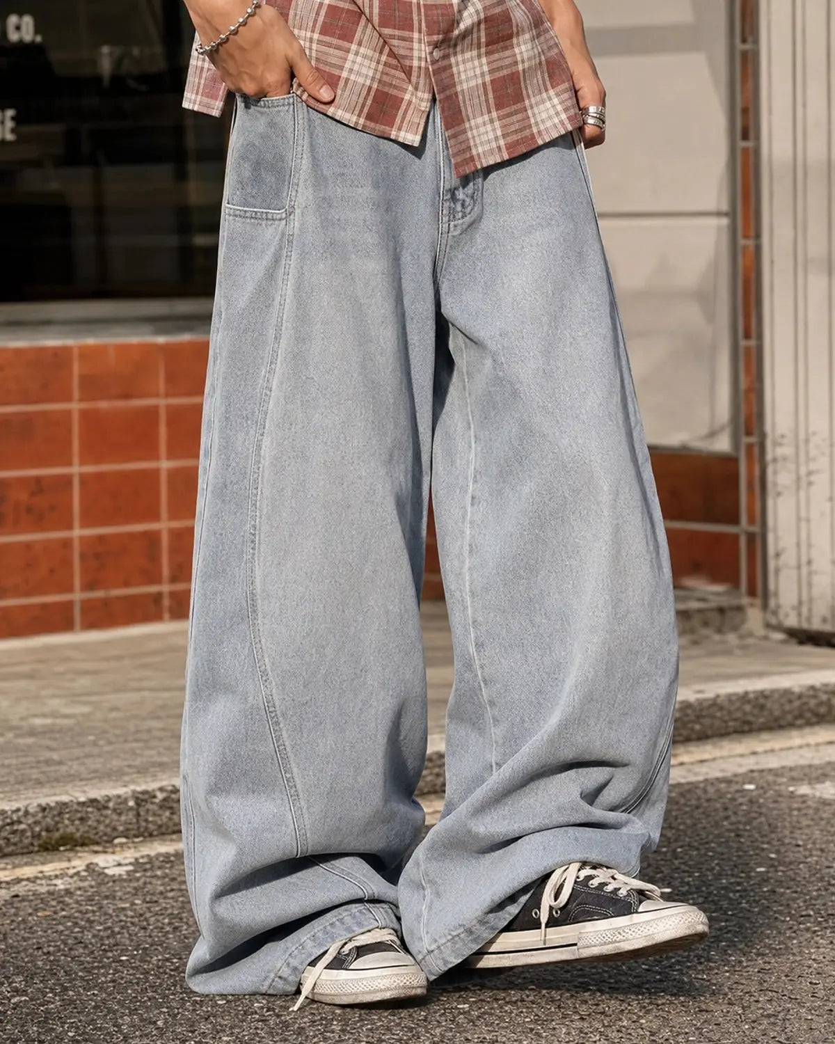 Acid washed distressed barrel jeans by INFLATION, showcasing a relaxed fit with ripped details and faded denim texture.