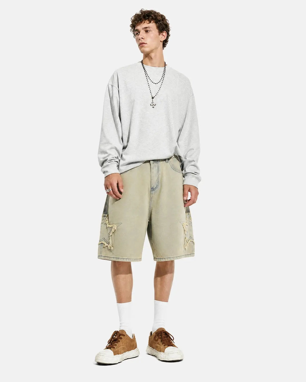 Inflation Star Patch Distressed Baggy Jorts featuring star patches, ripped details, and a relaxed fit, styled as streetwear denim shorts.
