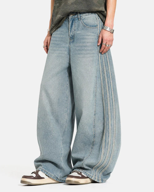 Acid wash striped side baggy jeans by INFLATION, featuring a relaxed fit and bold striped pattern for streetwear style.
