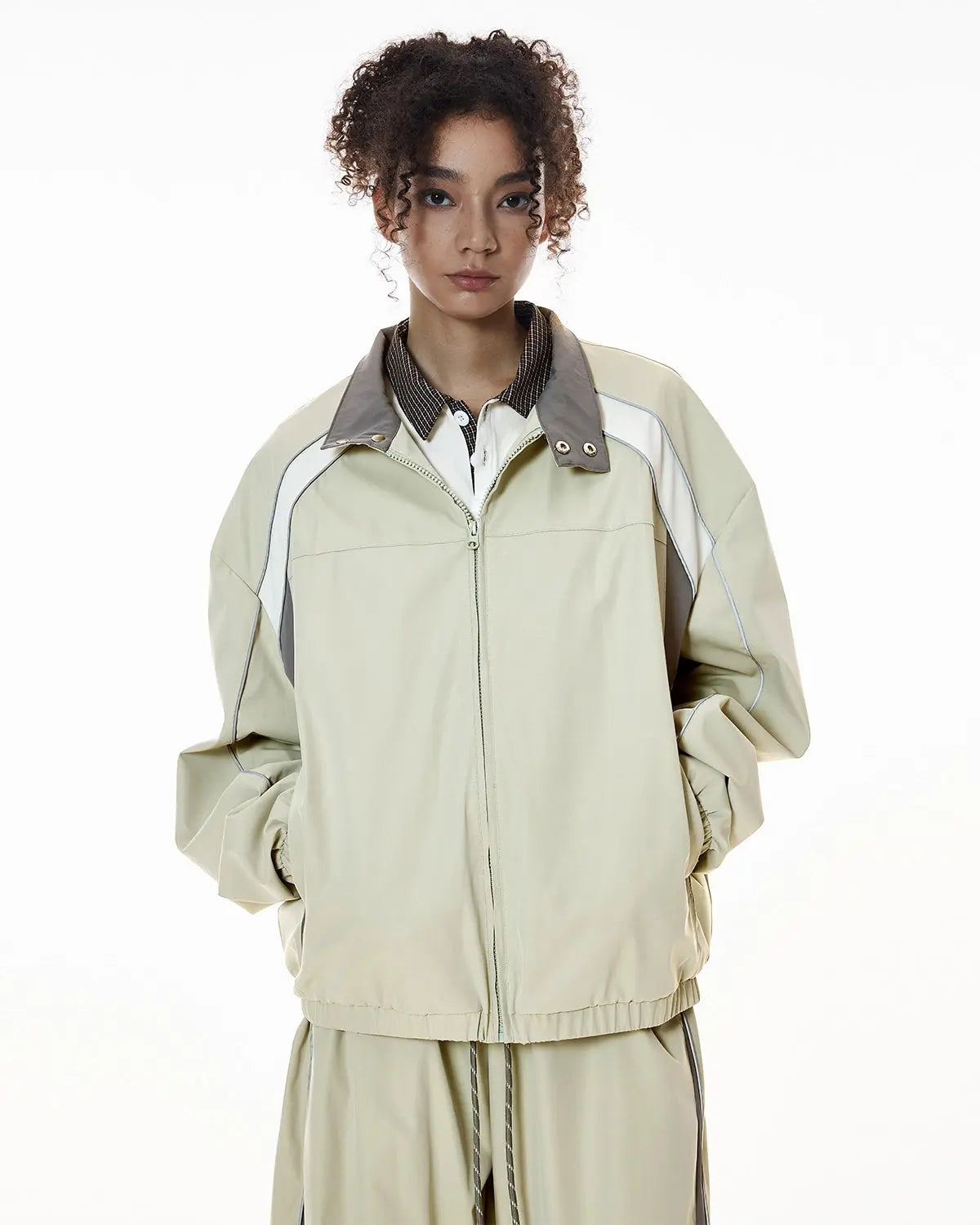 Reflective windbreaker track jacket by INFLATION, featuring a sleek design with reflective accents for streetwear style.