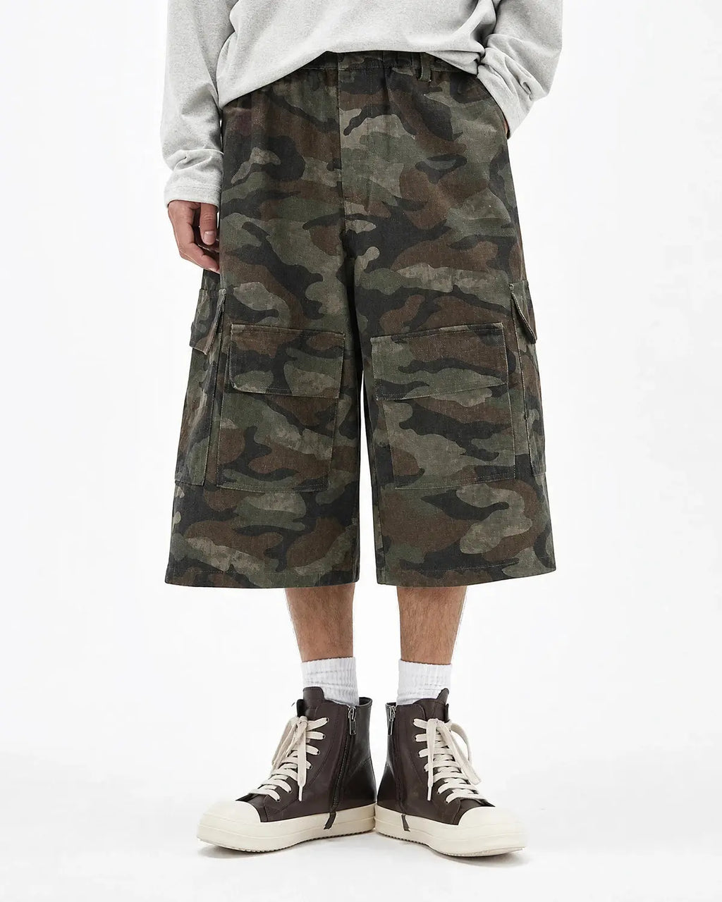 Grey camo utility longline shorts by INFLATION featuring multiple pockets and a relaxed fit, perfect for streetwear style.