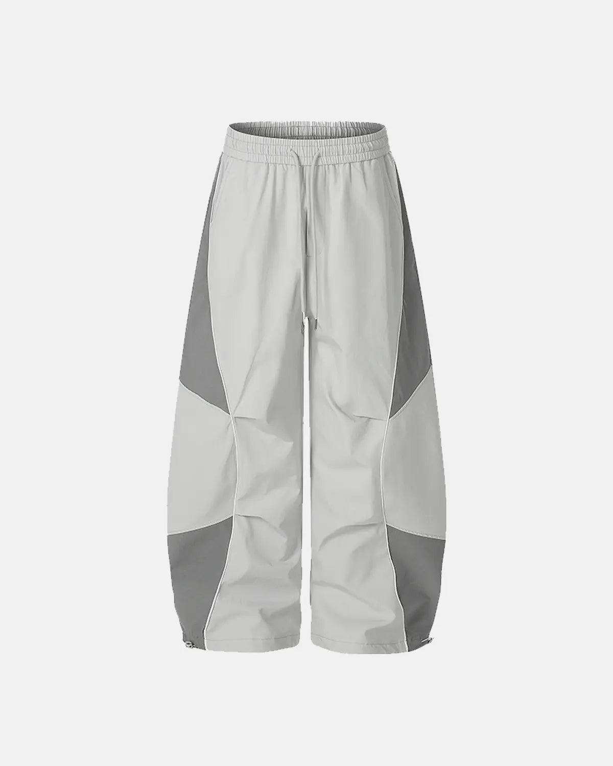 Inflation Streetwear contrast panel baggy track pants with black and white color blocks and relaxed fit, casual athletic style.