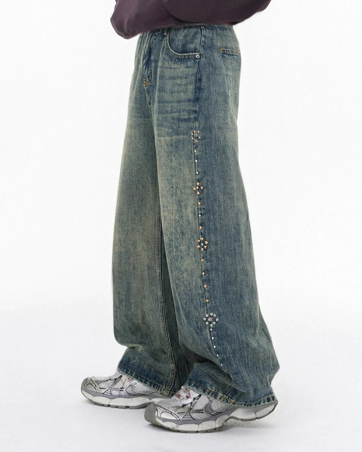 Acid wash beaded studded flared baggy jeans by INFLATION Streetwear, showing distressed fabric, beaded embellishments, and wide flare.