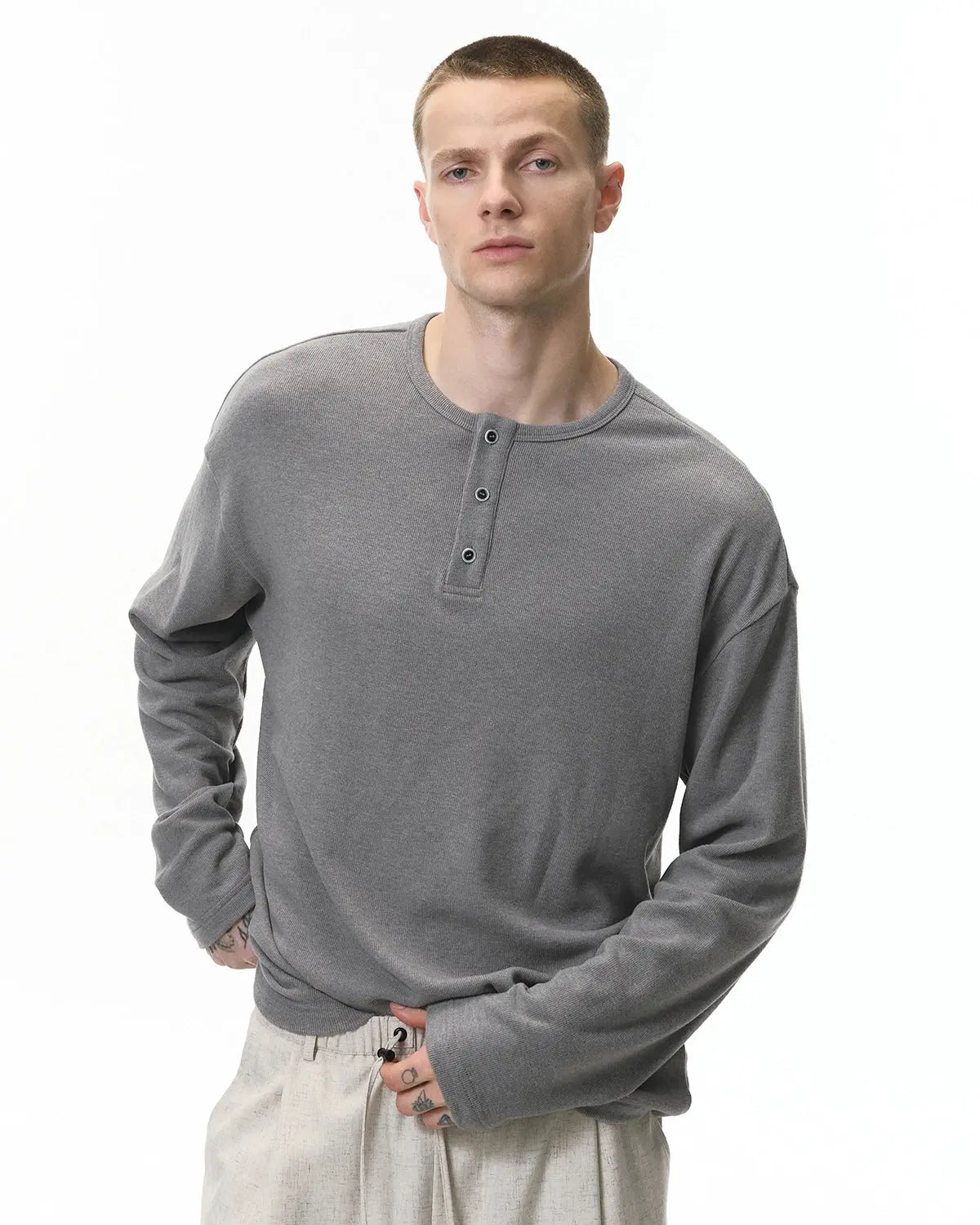 Inflation Streetwear Henley collar long sleeve T-shirt, casual black tee with buttoned neckline and comfortable fit.