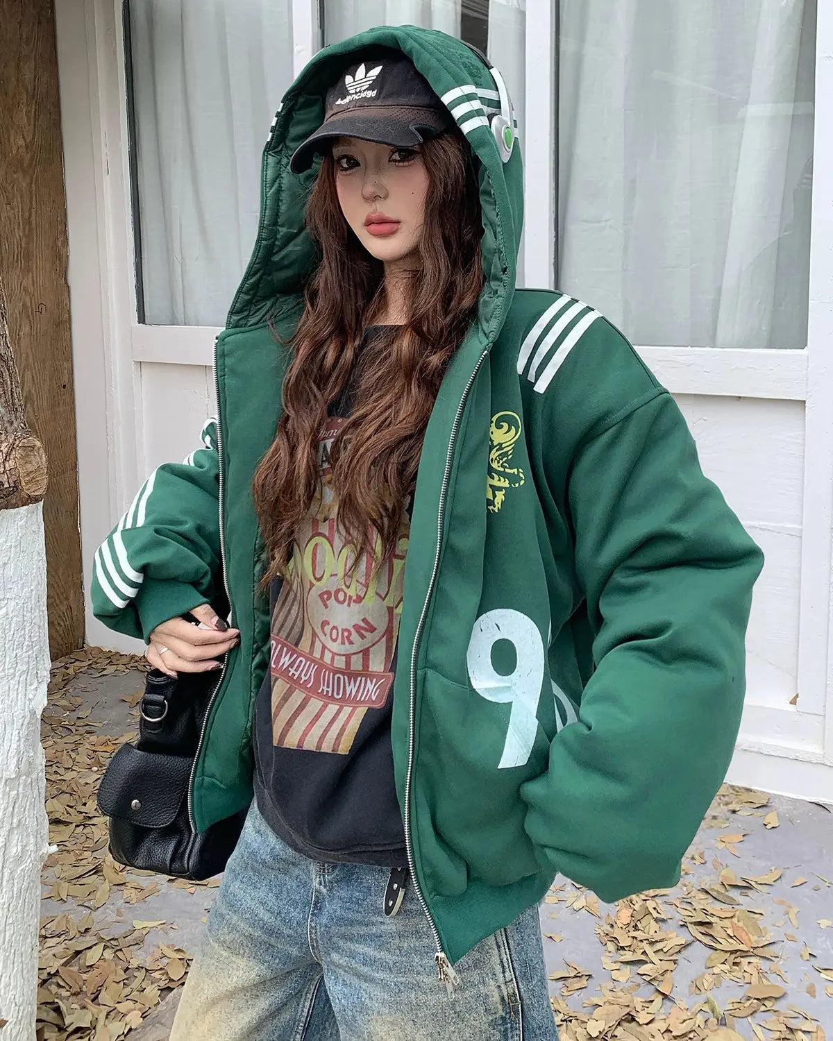 Gothic striped hooded bomber jacket by INFLATION featuring black-and-white stripes and a relaxed streetwear style.