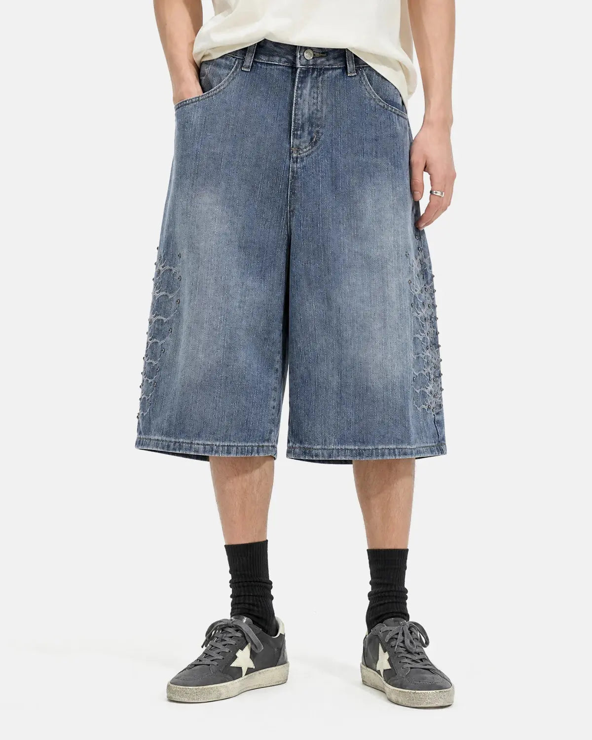 Inflation brand studded bamboo weave jorts, denim-style pants with metal stud embellishments and a casual streetwear design.