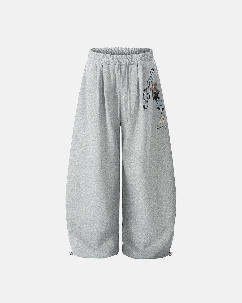 Inflation Streetwear Applique Baggy Sweatpants in black with large side pockets and relaxed fit, featuring bold applique details.