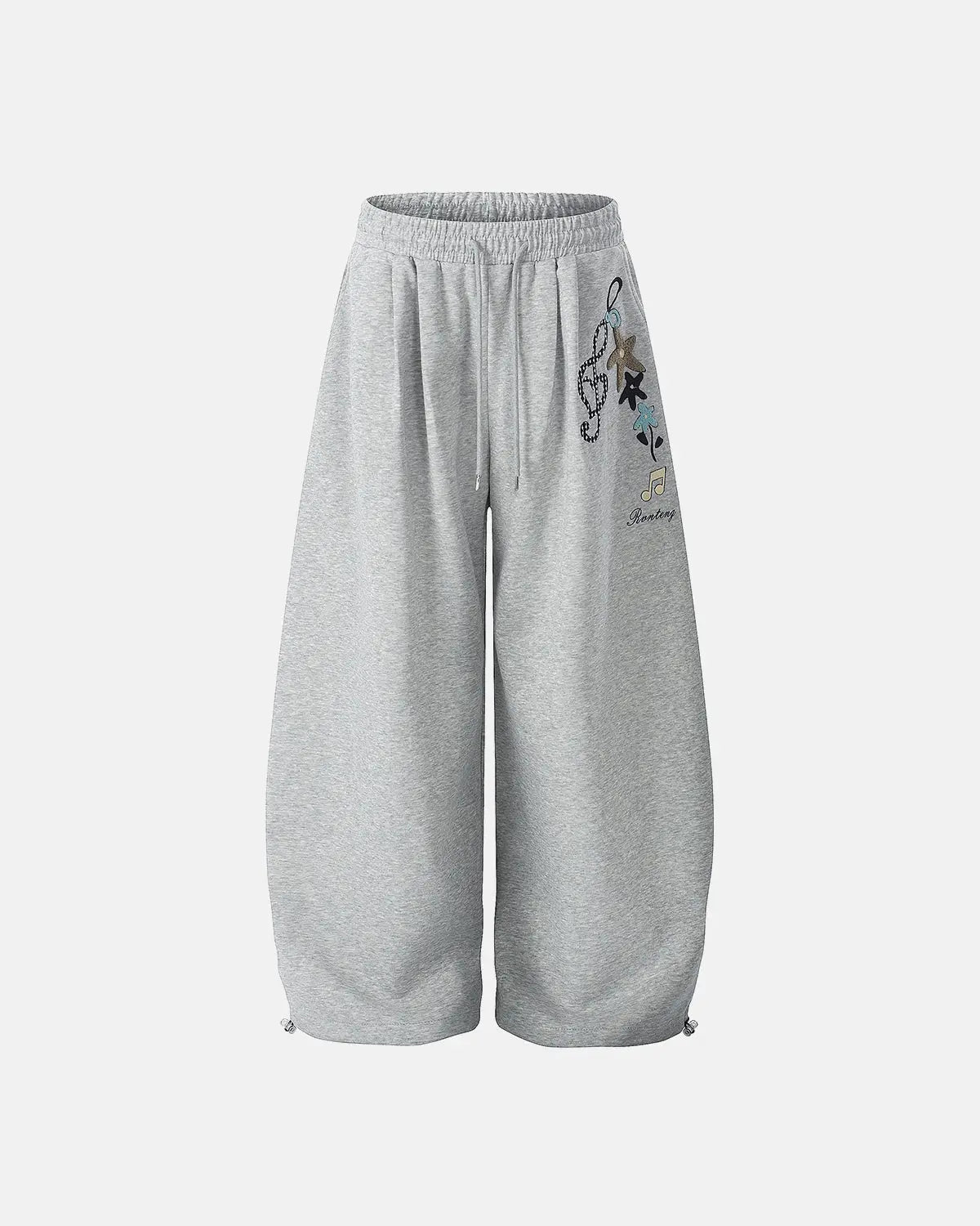 Inflation Streetwear Applique Baggy Sweatpants in black with large side pockets and relaxed fit, featuring bold applique details.