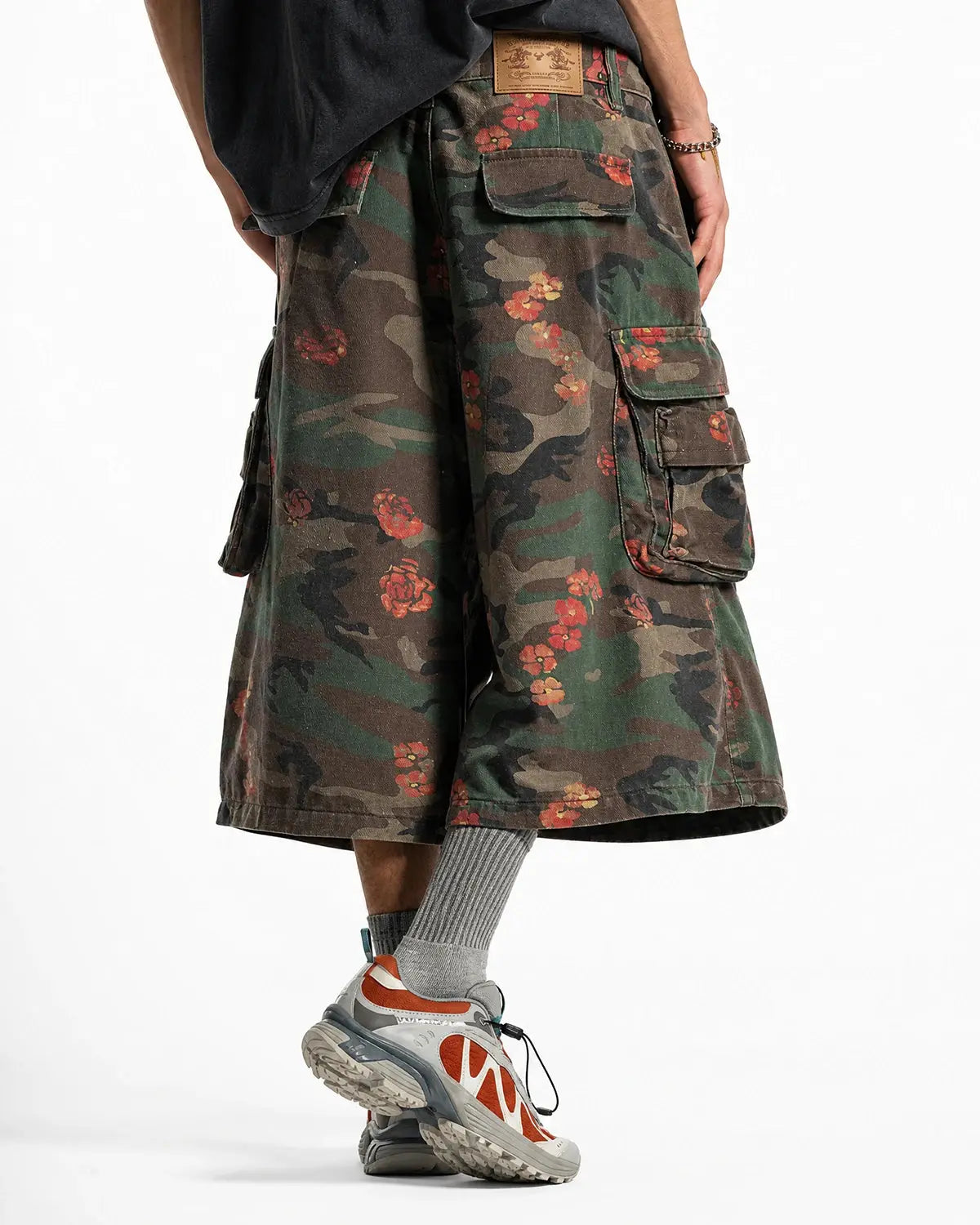 Inflation Floral Camo Cargo Longline Shorts featuring a mix of floral and camo patterns, with multiple pockets and a relaxed fit.