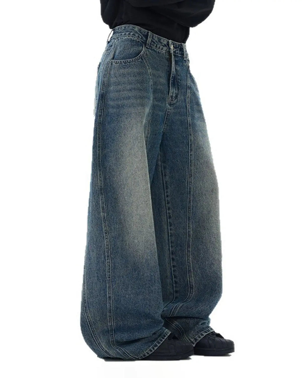 Deconstructed washed barrel jeans by INFLATION, streetwear style, showing distressed details and relaxed fit in a casual setting.