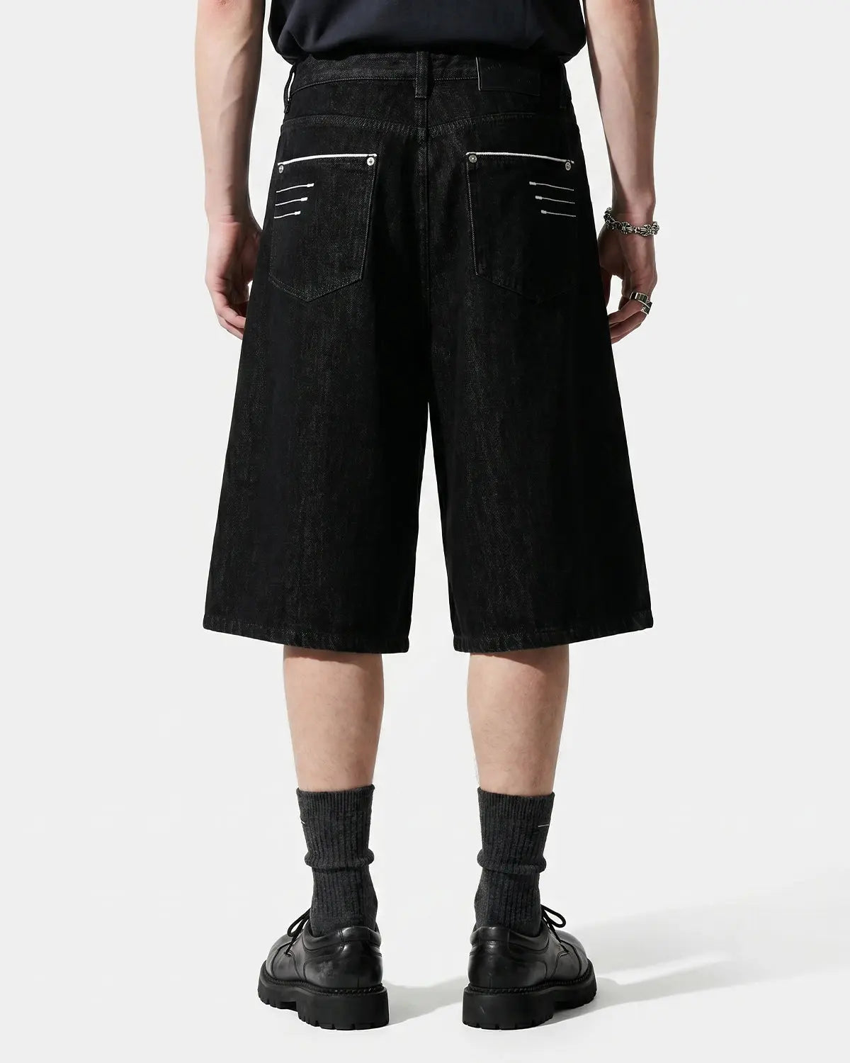 Inflation Streetwear longline wide-leg jorts pants in denim with distressed details and relaxed fit, styled on a model.