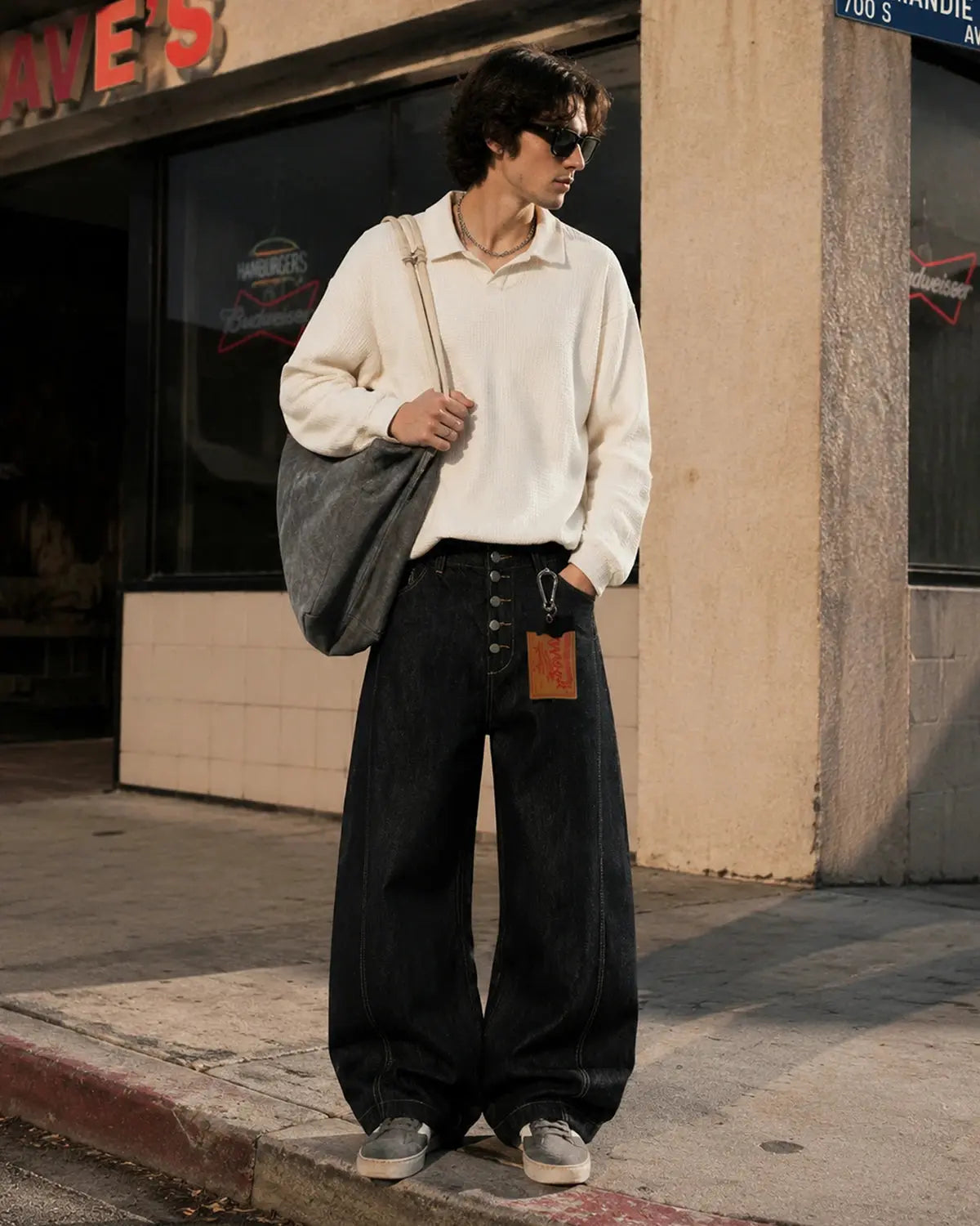 Black buttons-up barrel baggy jeans from INFLATION Streetwear, featuring relaxed fit and casual style with prominent button details.