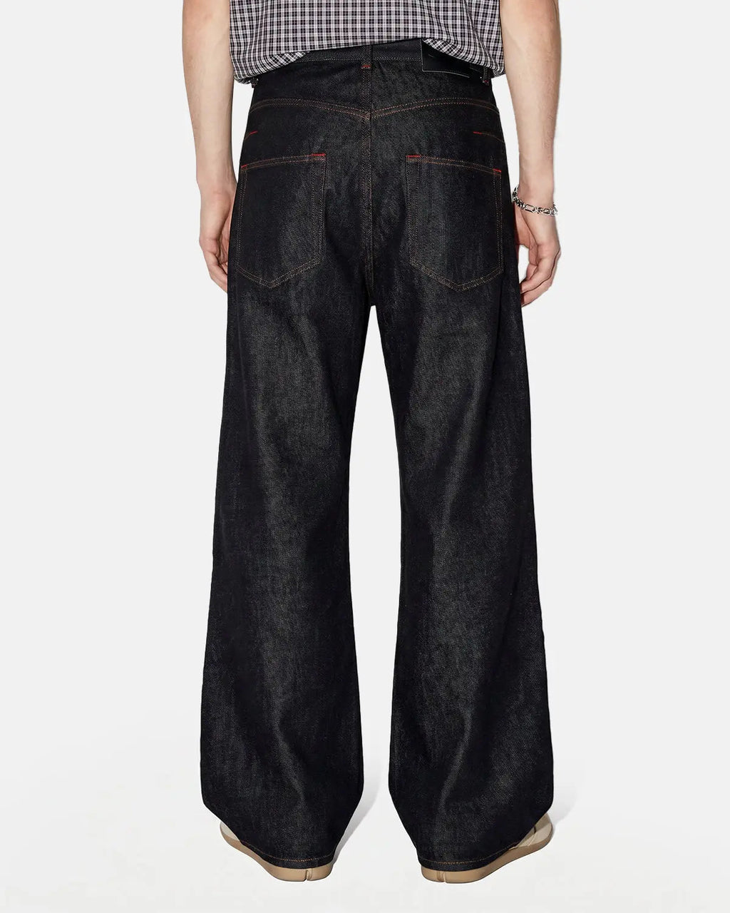 Asymmetric buckle raw baggy jeans by INFLATION featuring a loose fit and unique buckle detail, styled for streetwear fashion.