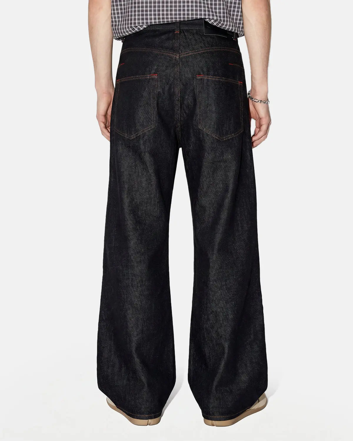 Asymmetric buckle raw baggy jeans by INFLATION featuring a loose fit and unique buckle detail, styled for streetwear fashion.