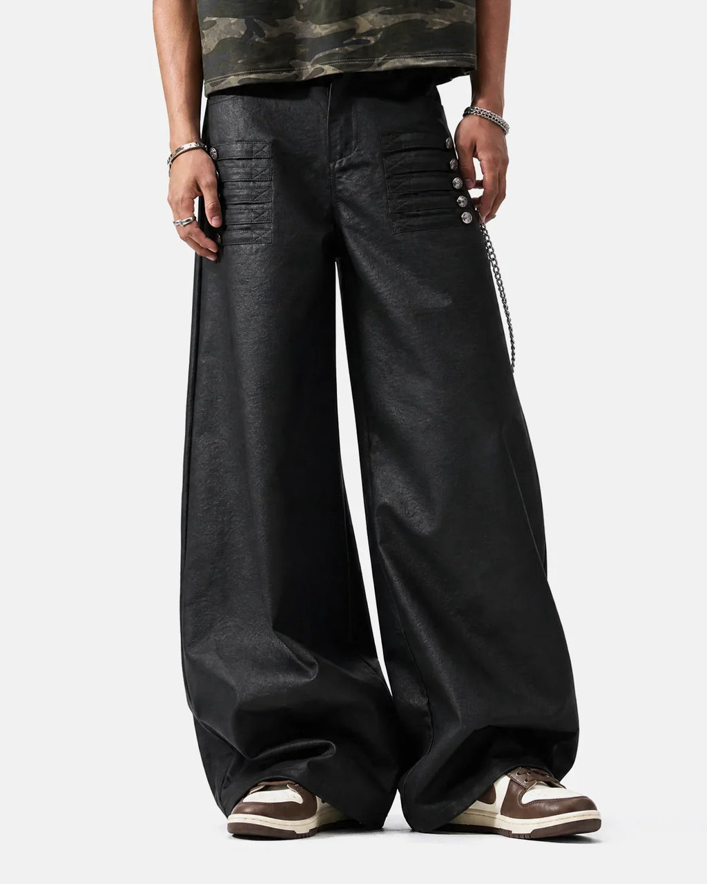 Black graphic wide leg pants by INFLATION featuring bold designs and a relaxed fit, shown on a model.