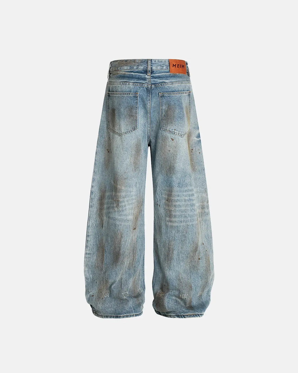 Distressed barrel jeans by INFLATION featuring a dirty wash, with a relaxed fit and distressed details, stylish streetwear look.