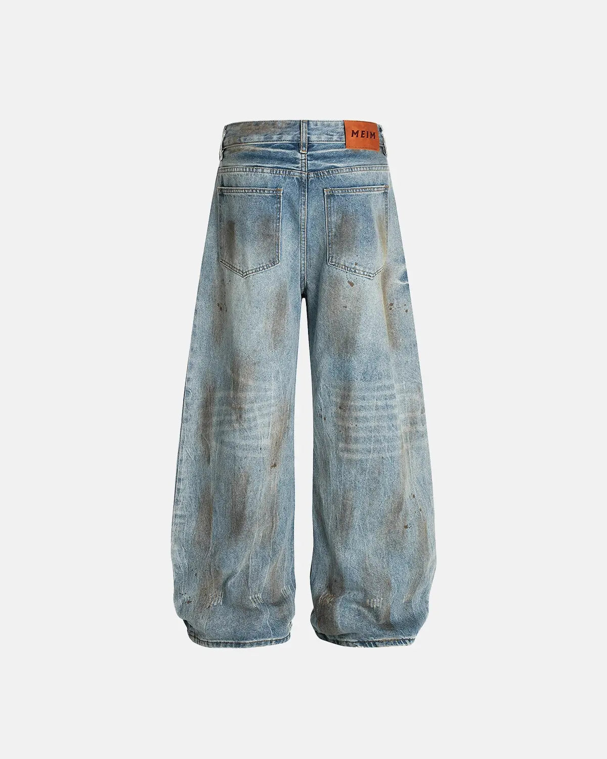 Distressed barrel jeans by INFLATION featuring a dirty wash, with a relaxed fit and distressed details, stylish streetwear look.