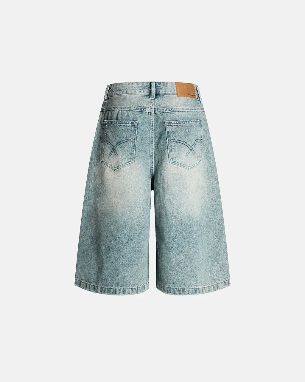 Distressed longline jorts by INFLATION, casual denim pants with frayed edges and a relaxed fit, styled for streetwear fashion.