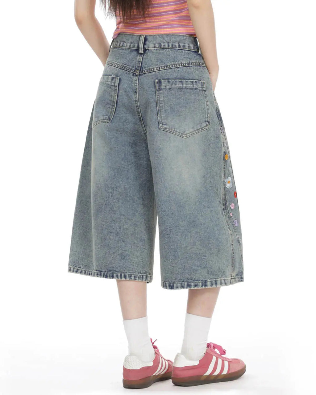 Inflation brand floral embroidered long baggy jorts, stylish pants with colorful floral embroidery, relaxed streetwear style.