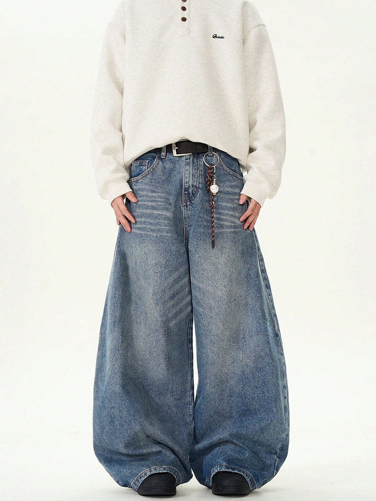Inflation vintage distressed denim jeans with wide leg and loose fit, showcasing a stylish, relaxed fit design on a model.