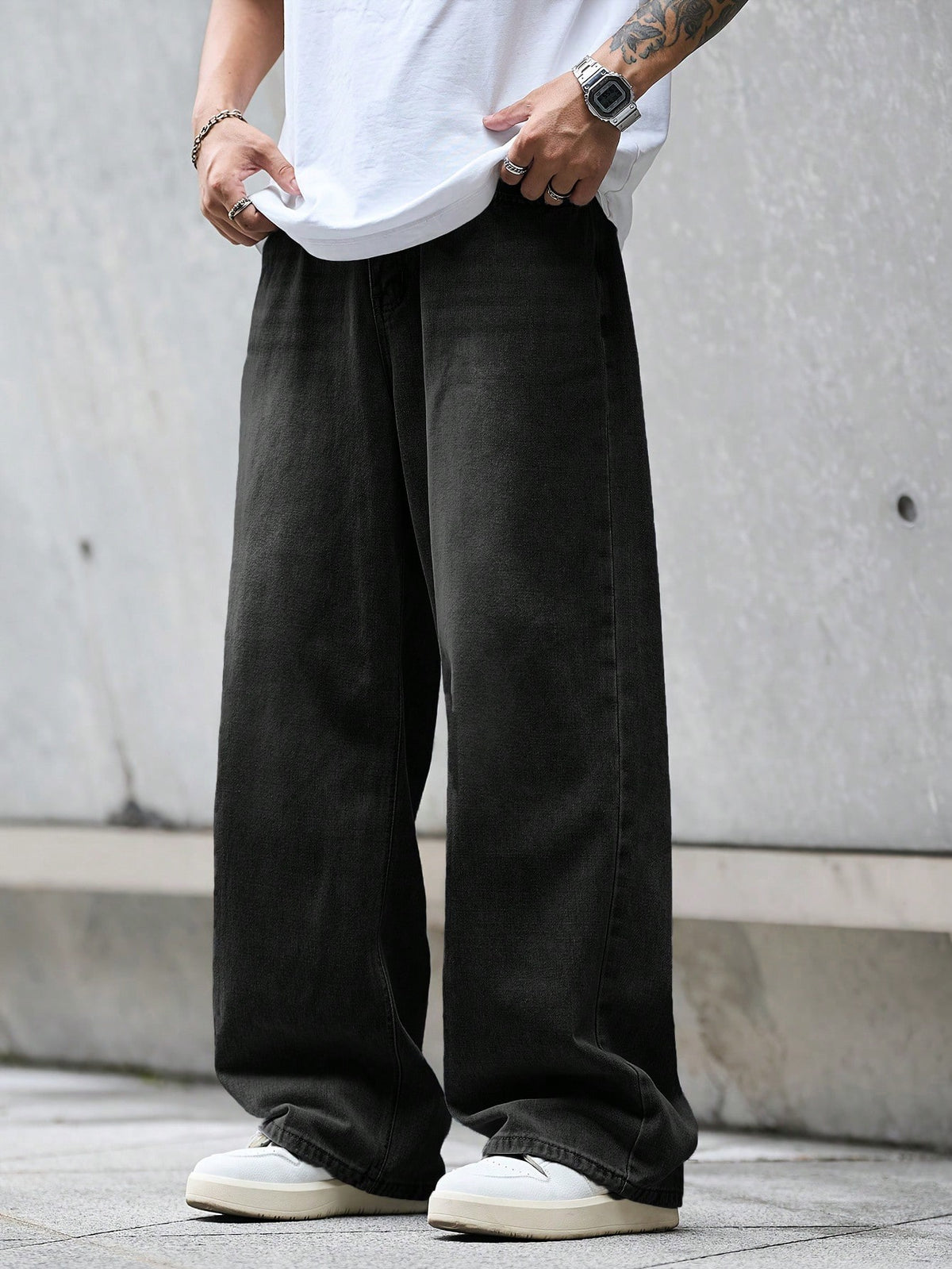 Black loose denim jeans by Inflation in street style, featuring a relaxed fit and classic five-pocket design.