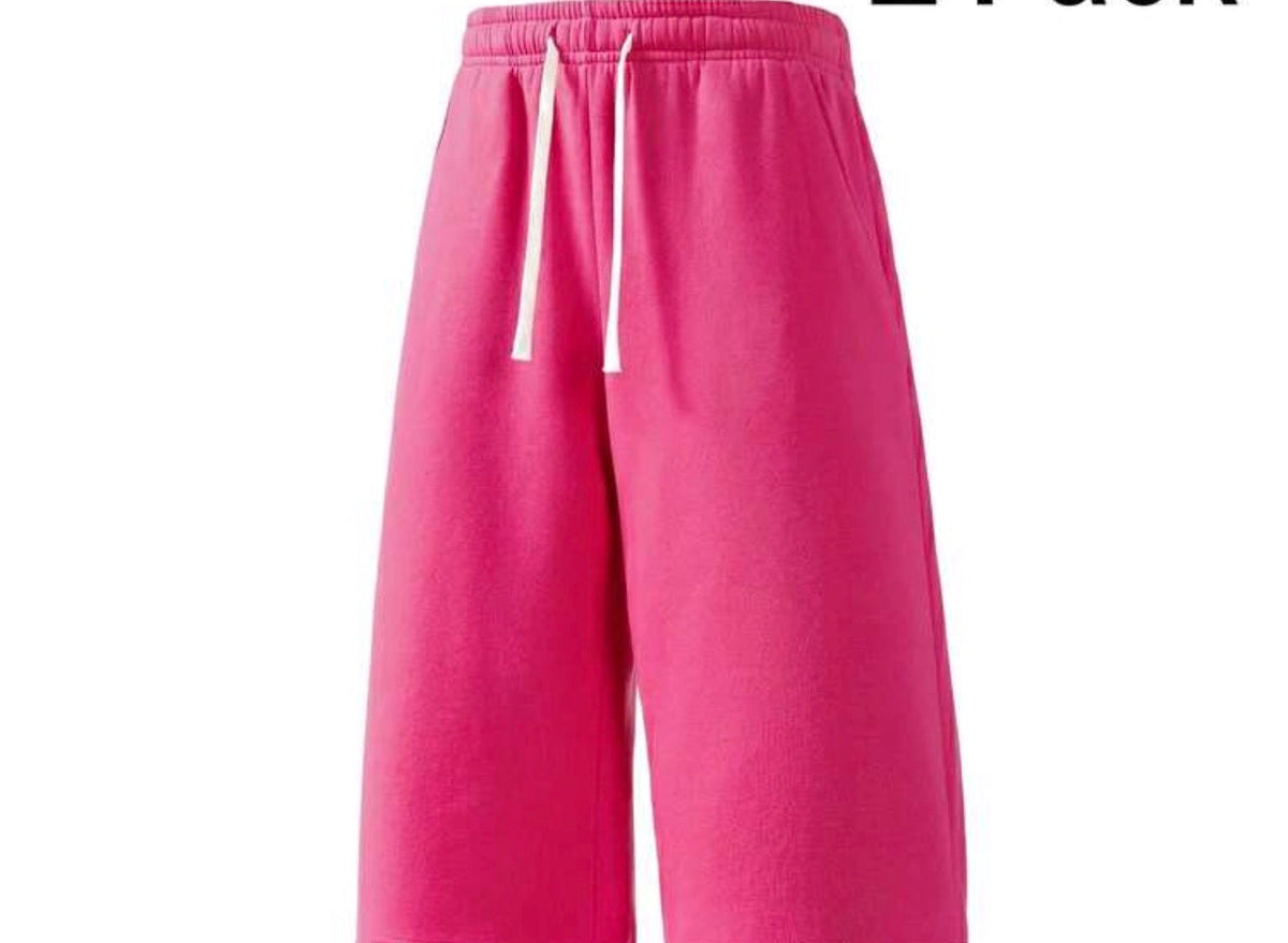 Inflation trending long jogger shorts in black with elastic waistband, side pockets, and relaxed fit for casual comfort.